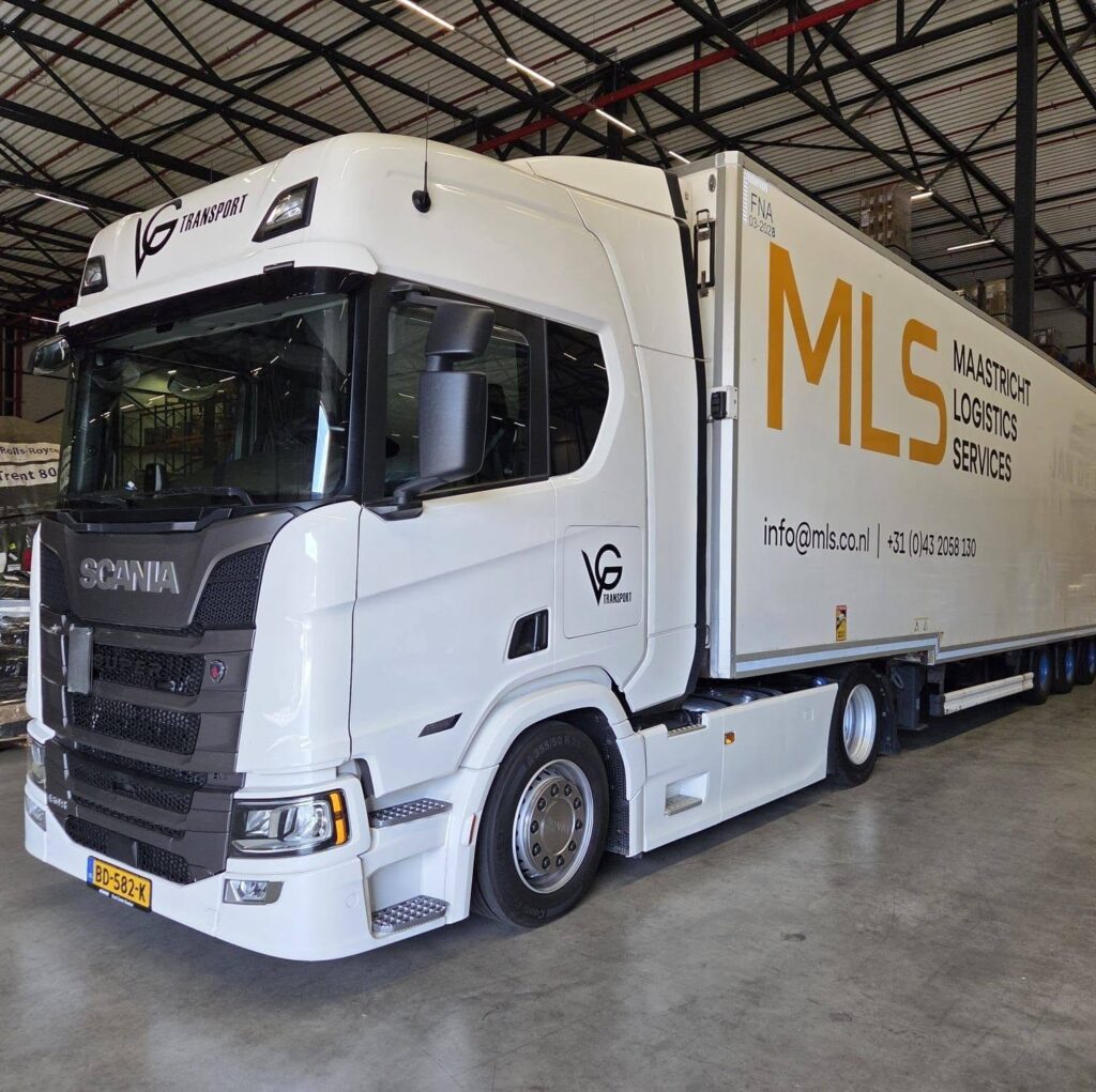 Witte VG-trekker met oplegger in een loods